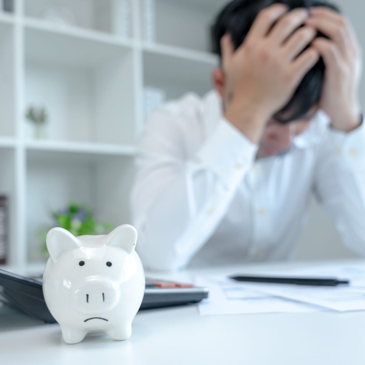 Stressed and headache asian man with large bills or invoices no Stressed and headache asian man with large bills or invoices no money to pay to expenses and credit card debt. shortage, Financial problems, mortgage, loan, bankruptcy, bankrupt, poor, empty wallet
